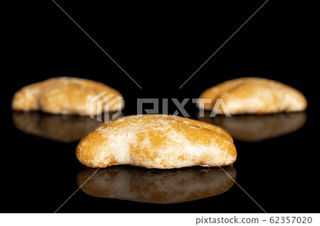 Sweet brown gingerbread isolated on black glass Sweet brown gingerbread isolated on black glass 62357020