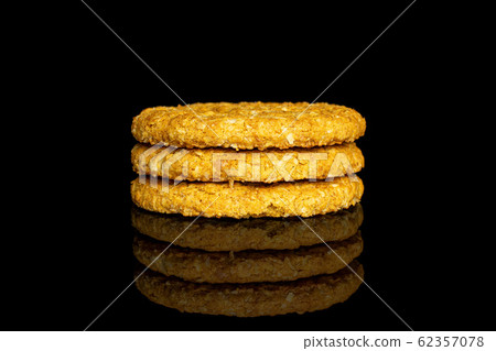Sweet oat cookie isolated on black glass Sweet oat cookie isolated on black glass 62357078