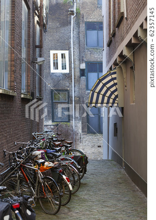 Old small vintage street with bicycles and an 62357145