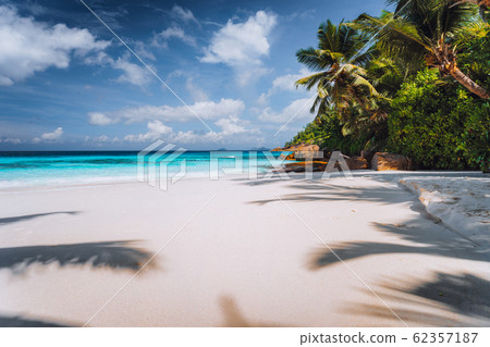 Idyllic perfect tropical pristine tranquil beach with powdery white sand, crystal clear ocean water. Summer time vacation and lifestyle Idyllic perfect tropical pristine tranquil beach with powdery white sand, crystal clear ocean water. Summer time vacation and lifestyle 62357187