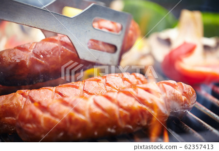 Grilling Sausages on barbecue grill 62357413