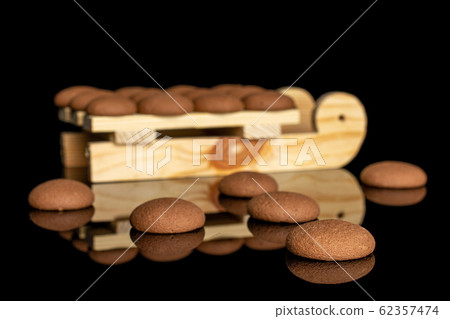 Chocolate sponge biscuit isolated on black glass Chocolate sponge biscuit isolated on black glass 62357474
