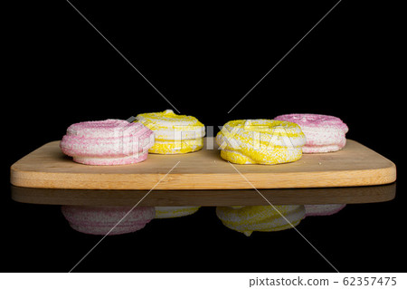 Sweet pastel meringue isolated on black glass Sweet pastel meringue isolated on black glass 62357475