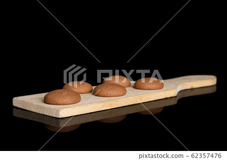 Chocolate sponge biscuit isolated on black glass Chocolate sponge biscuit isolated on black glass 62357476