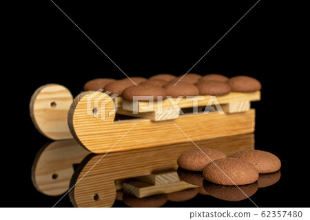 Chocolate sponge biscuit isolated on black glass Chocolate sponge biscuit isolated on black glass 62357480