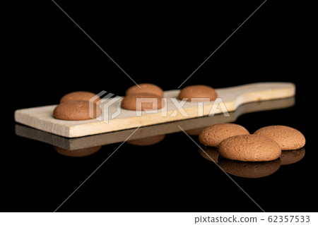 Chocolate sponge biscuit isolated on black glass Chocolate sponge biscuit isolated on black glass 62357533