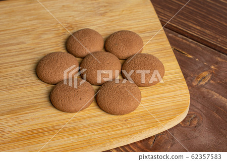 Chocolate sponge biscuit on brown wood Chocolate sponge biscuit on brown wood 62357583