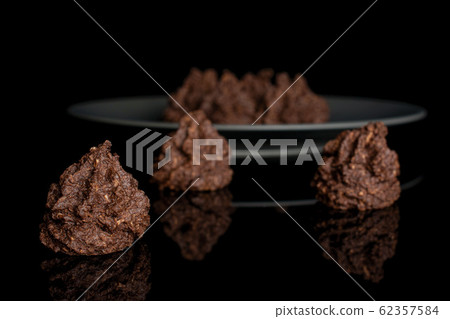 Coconut cocoa biscuit isolated on black glass Coconut cocoa biscuit isolated on black glass 62357584