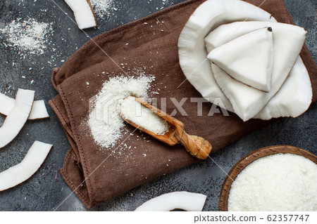 Coconut flour in a wooden spoon close up 62357747
