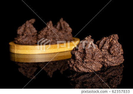 Coconut cocoa biscuit isolated on black glass Coconut cocoa biscuit isolated on black glass 62357833