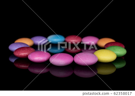 Sweet colourful candy isolated on black glass Sweet colourful candy isolated on black glass 62358017