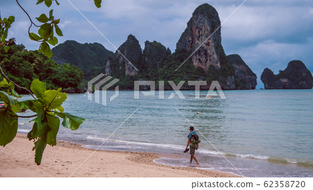 Lonely Traveler on Railay Beach in Krabi Thailand. Asia Lonely Traveler on Railay Beach in Krabi Thailand. Asia 62358720