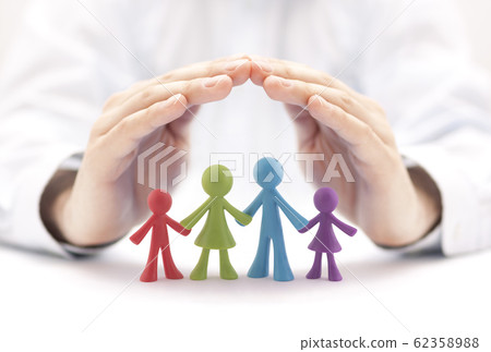 Family insurance concept with colorful family figurines covered by hands Family insurance concept with colorful family figurines covered by hands 62358988