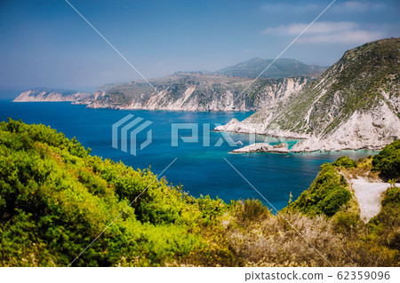 Coastline near Agia Eleni and Pitani beach in Kefalonia Island, Greece. Most beautiful rocky wild beaches with clear emerald water and high white limestone cliffs landscape 62359096