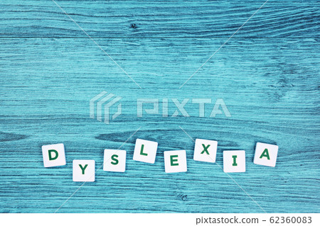Dyslexia concept, word on blue desk Dyslexia concept, word on blue desk 62360083