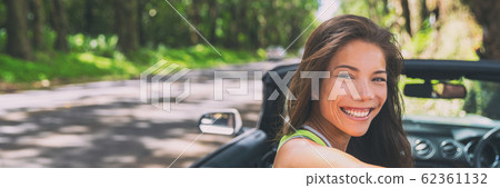 Asian car driver woman smiling happy relaxing in convertible car on summer road trip vacation. Travel destination driving through Hawaii, banner panorama 62361132