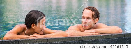 Wellness spa pool couple relaxing in hydrotherapy luxury travel resort on tropical holidays together enjoying the swim in water. Banner panorama. Hotel swimming pool Wellness spa pool couple relaxing in hydrotherapy luxury travel resort on tropical holidays together enjoying the swim in water. Banner panorama. Hotel swimming pool 62361545