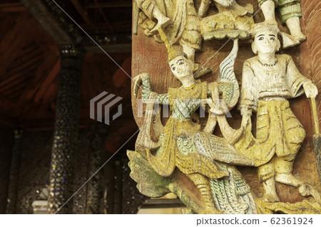 Wood carving, which has Burmese art style, is used for decorating the doors in the temple. Wood carving, which has Burmese art style, is used for decorating the doors in the temple. 62361924