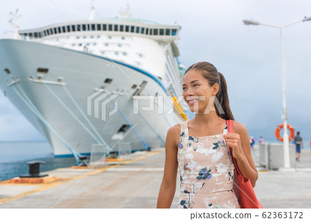 Cruise ship passenger leaving boat for shore excursion in harbour. Asian woman tourist spending a day in port of call of Caribbean travel destination. 62363172