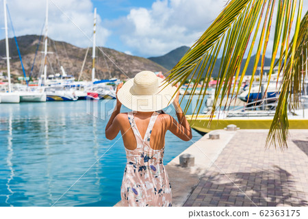 Young woman with sun hat in Philipsburg marina harbor, St Maarten, popular port of call for cruise ship travel destination. Netherlands Antilles, tropical summer vacation. 62363175