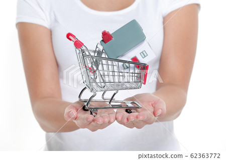 Real estate shopping buying a new house concept. Woman showing miniature small toy model on open hands. Isolated on white background 62363772