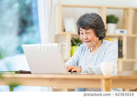 Grandma using a computer Portrait of senior woman Silver generation Elderly woman Grandma using a computer Portrait of senior woman Silver generation Elderly woman 62363819