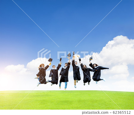 happy students in graduation gowns celebrating happy students in graduation gowns celebrating 62365512