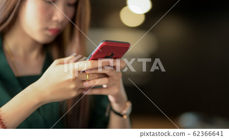 Cropped shot of businesswoman using smartphone in 62366641