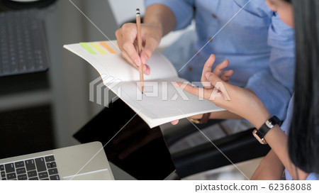 Cropped shot of businesspeople discussing on their Cropped shot of businesspeople discussing on their 62368088