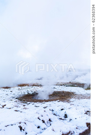 An erupting soaring geyser in the Valley of 62368394