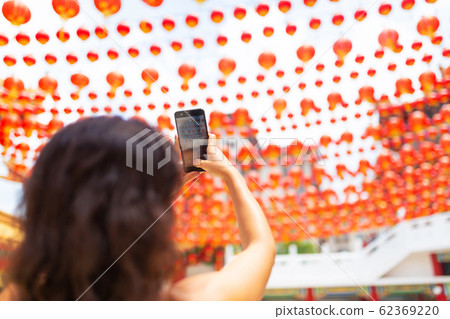 A tourist girl photographs the festive New Year A tourist girl photographs the festive New Year 62369220