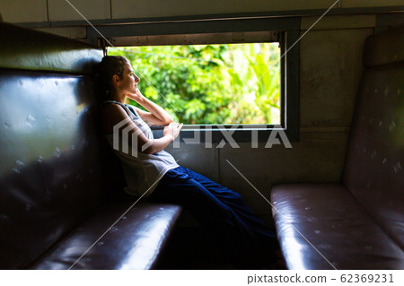 Train ride in Sri Lanka. Woman sitting and looking 62369231