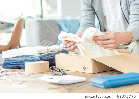 Hand of a young man trying to put out clothes that do not need Mercari 62370779