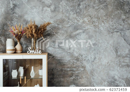 artifiacial flower in vase on top of wooden sideboard. studio shoot 62371459