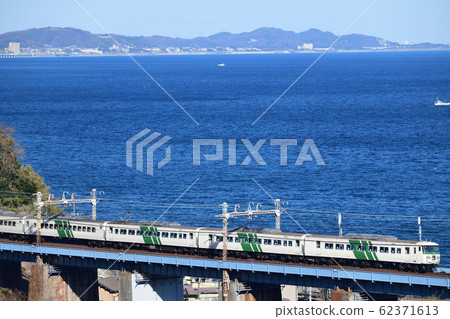 Limited express dancer crossing the iron bridge overlooking Sagami Bay Limited express dancer crossing the iron bridge overlooking Sagami Bay 62371613