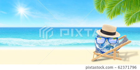 Blue planet earth laying relax on beach chair on sand beach with beautiful seascape view in background. 62371796
