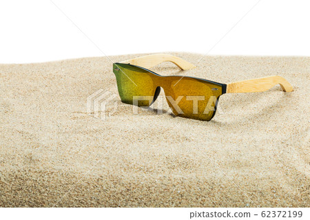 sunglasses with blue glasses on the sand in the desert 62372199