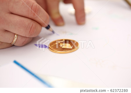 Golden ethereum coin lying at table closeup Golden ethereum coin lying at table closeup 62372280