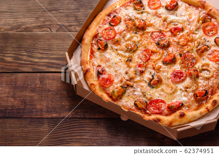 Tasty sliced pizza with seafood and tomato 62374951
