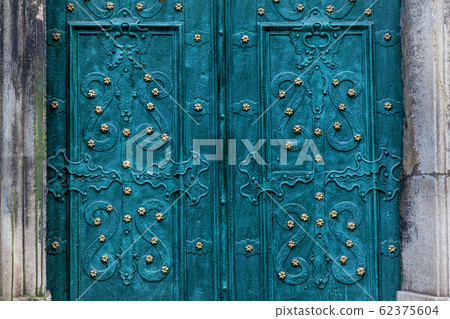A turquoise metal doors with a beautiful ornament A turquoise metal doors with a beautiful ornament 62375604