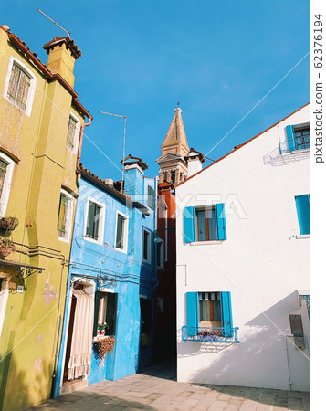 BURANO, ITALY - JANUARY 20, 2020: Colorful houses on the island of Burano in Italy. Burano island is famous for its colorful fisherman's houses. BURANO, ITALY - JANUARY 20, 2020: Colorful houses on the island of Burano in Italy. Burano island is famous for its colorful fisherman's houses. 62376194