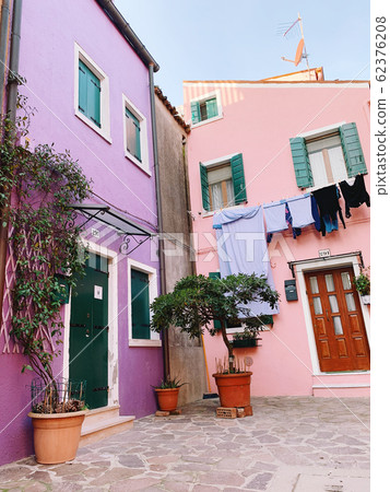BURANO, ITALY - JANUARY 20, 2020: Colorful houses on the island of Burano in Italy. Burano island is famous for its colorful fisherman's houses. 62376208