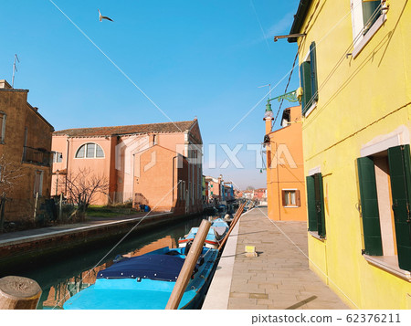 BURANO, ITALY - JANUARY 20, 2020: Colorful houses on the island of Burano in Italy. Burano island is famous for its colorful fisherman's houses. BURANO, ITALY - JANUARY 20, 2020: Colorful houses on the island of Burano in Italy. Burano island is famous for its colorful fisherman's houses. 62376211