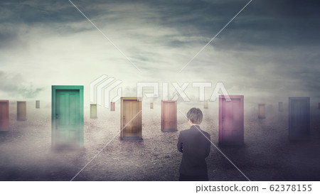 Businesswoman in front of many different doors 62378155