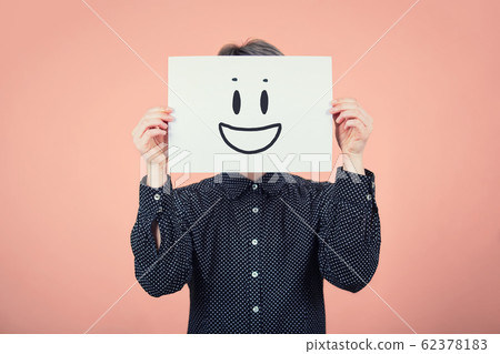 Businesswoman covering face using a white paper Businesswoman covering face using a white paper 62378183