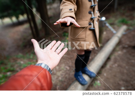 Parent and child hand playing in the park 62378578