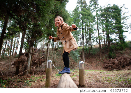 Girls playing in the park 62378752
