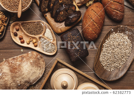 Whole grain multigrain bread, whole and sliced, contains seeds isolated on black Whole grain multigrain bread, whole and sliced, contains seeds isolated on black 62382773