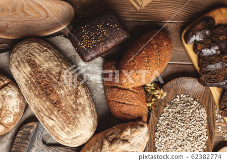 Whole grain multigrain bread, whole and sliced, contains seeds isolated on black 62382774