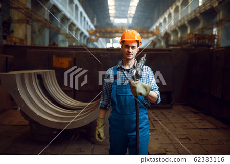 Male worker holds pneumatic jackhammer on factory Male worker holds pneumatic jackhammer on factory 62383116